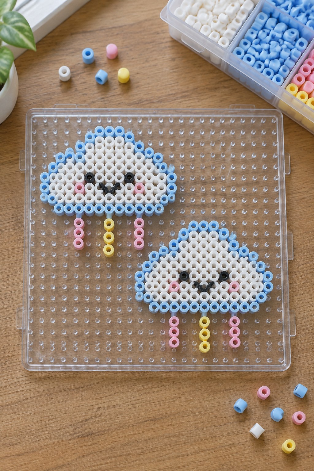 Two Perler bead sheep figures on clear pegboard with colorful bead organizer nearby