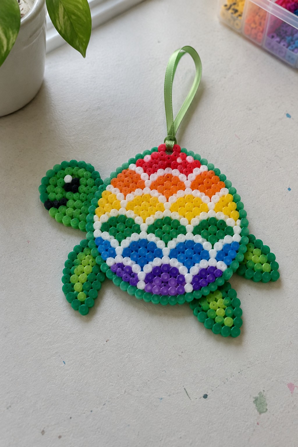 Rainbow perler bead turtle ornament with colorful shell and green ribbon hanger
