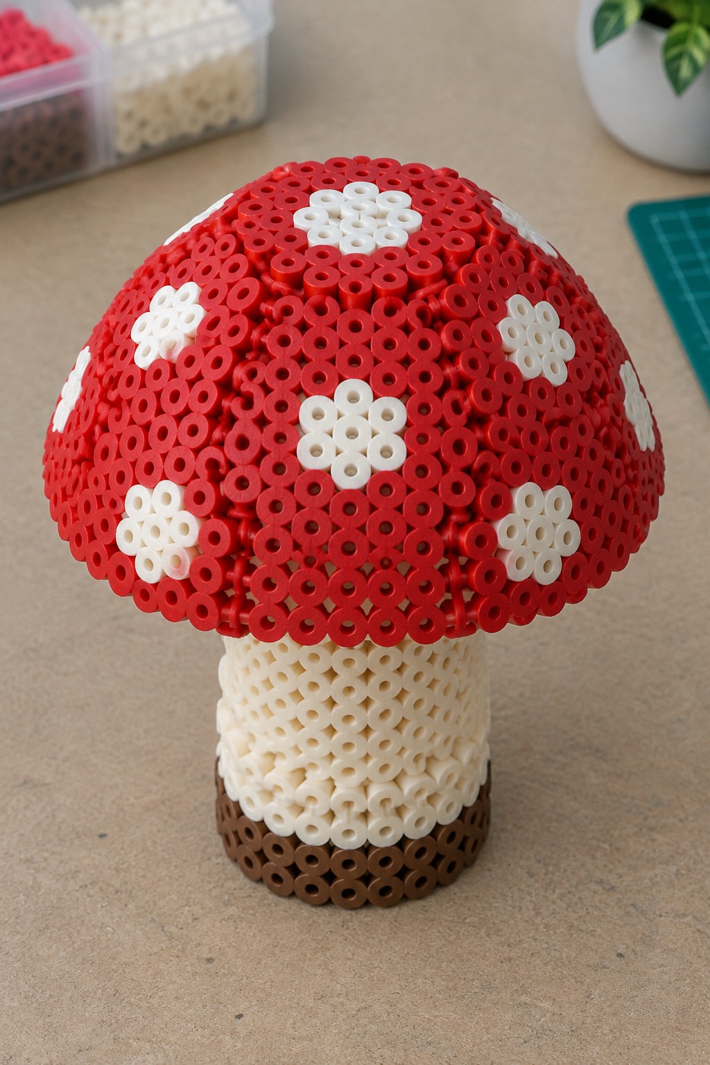 Red beaded mushroom with white spots and beige-brown stem on table