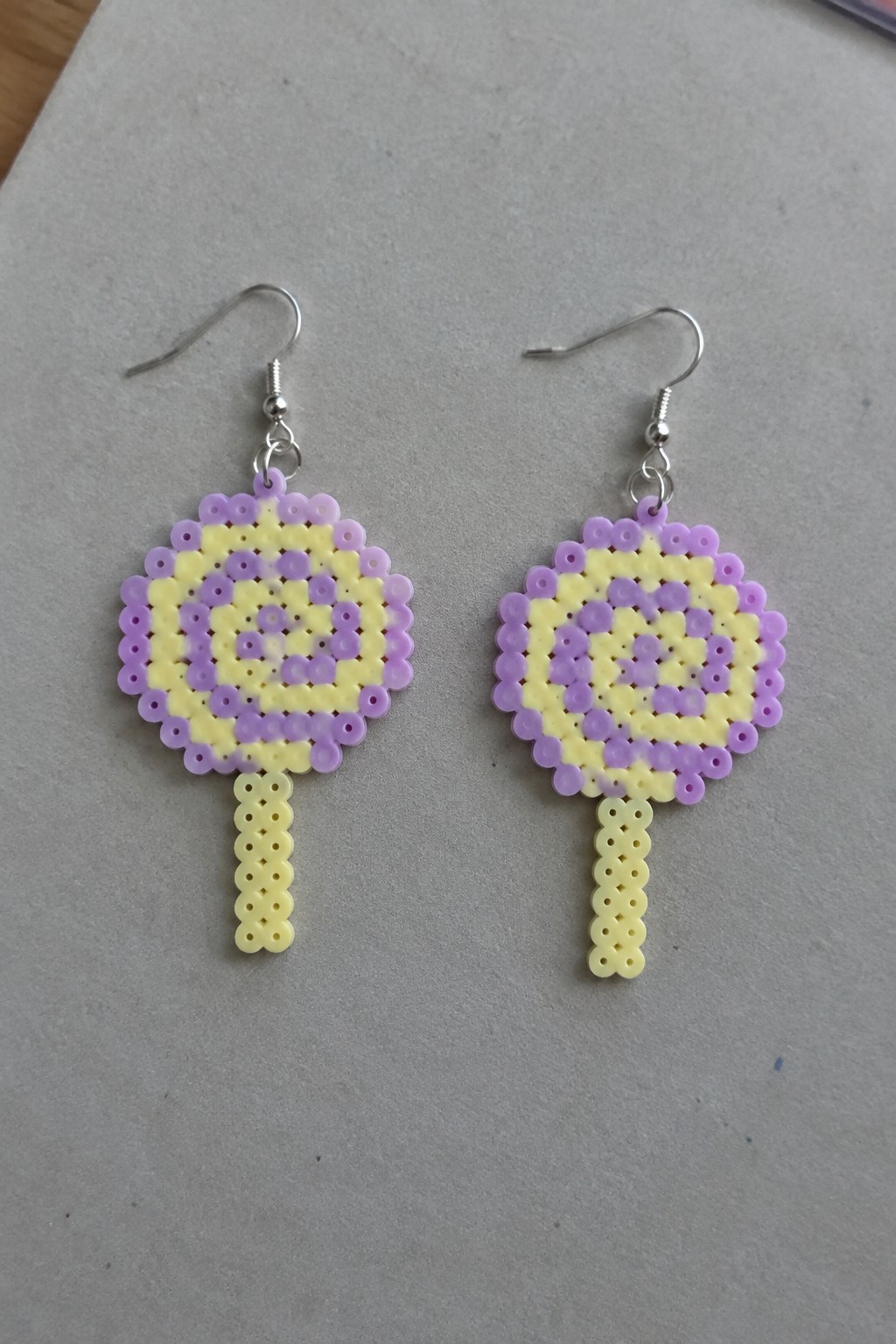 Pair of purple and yellow perler bead lollipop earrings with silver hooks