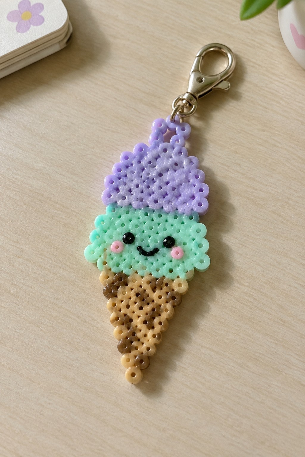 Perler bead ice cream cone keychain with purple scoop, mint face, and brown cone