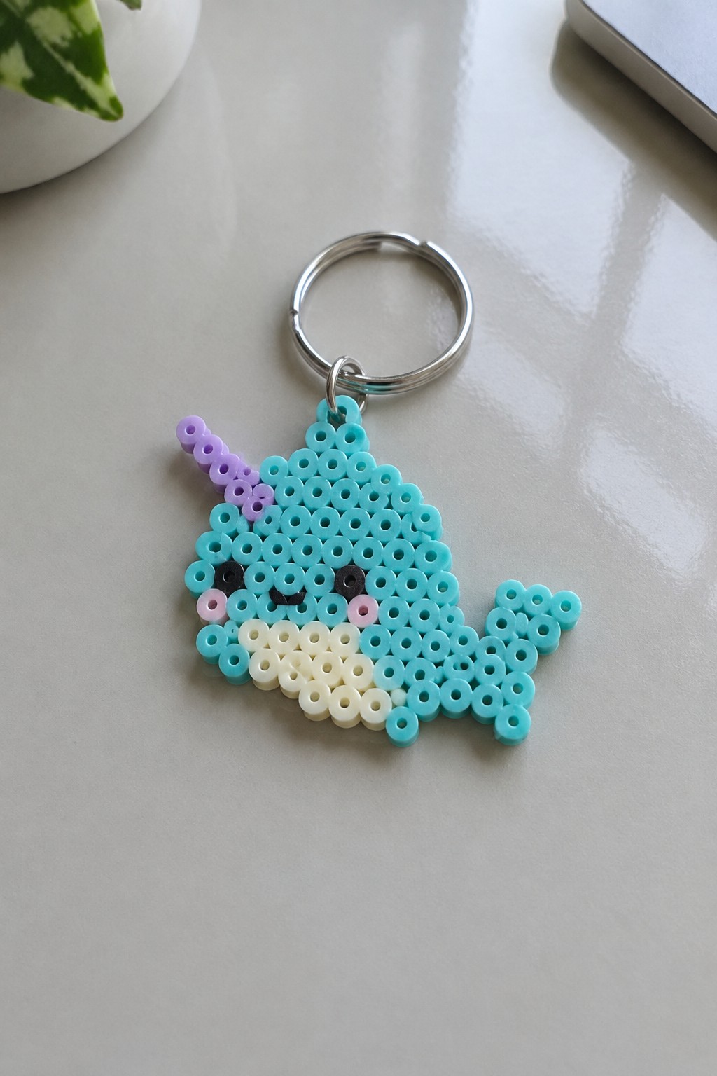 Cyan perler bead narwhal keychain with purple horn on silver ring
