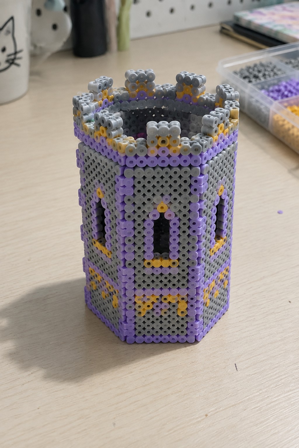 Purple gray and yellow perler bead castle tower with battlements and windows