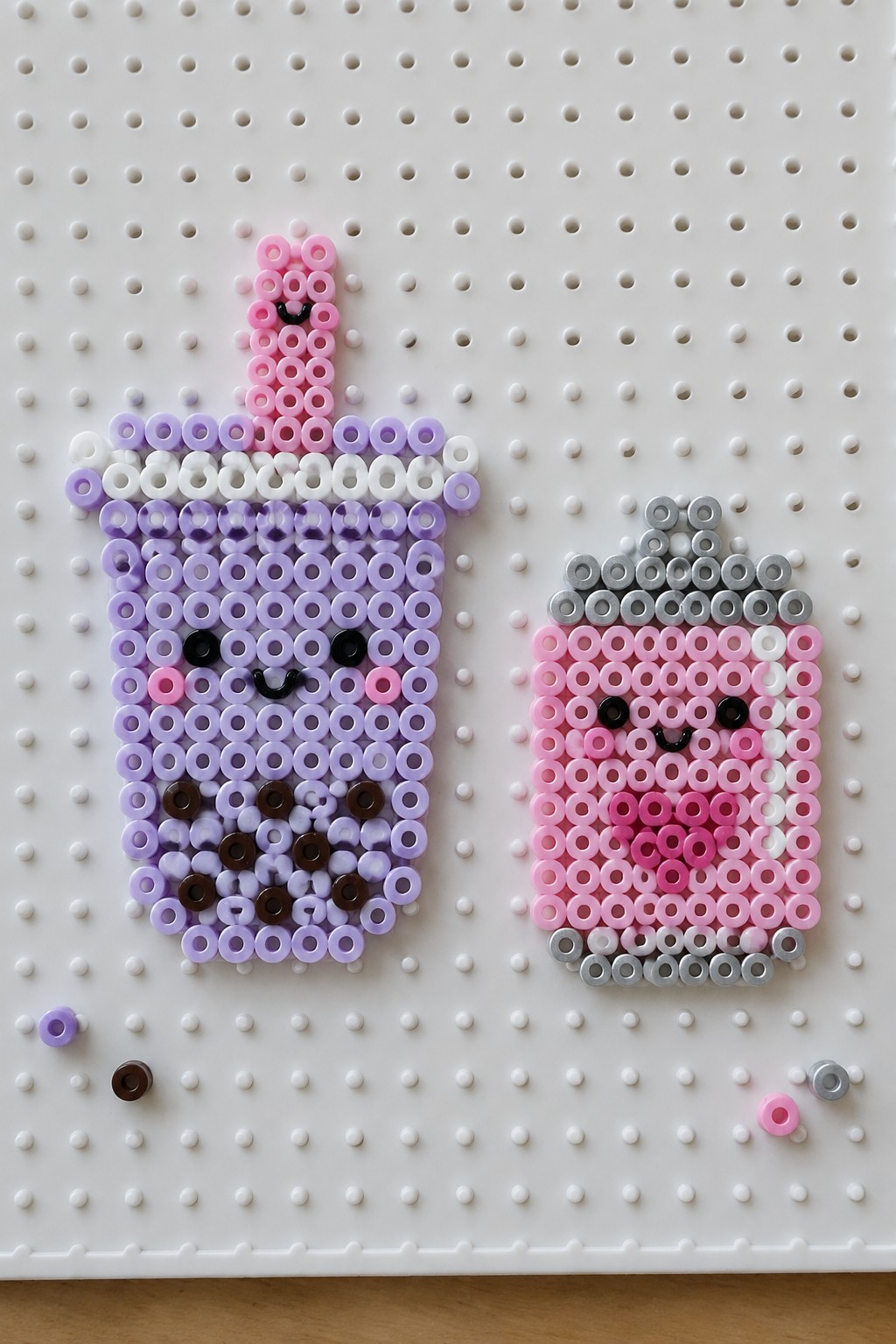 Kawaii perler bead crafts of purple bubble tea and pink milk carton on pegboard