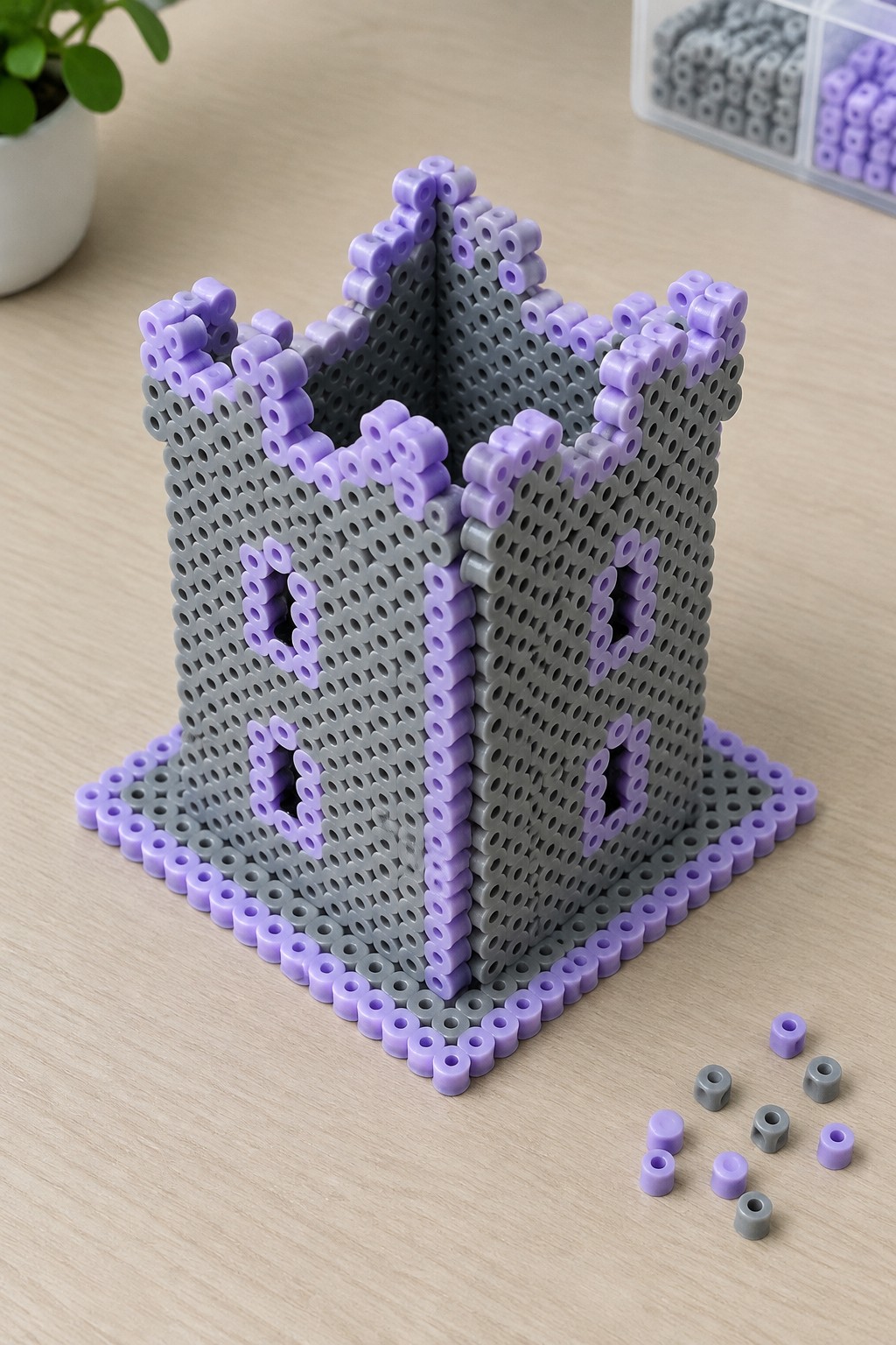 Gray and purple perler bead castle with cross windows on wooden table