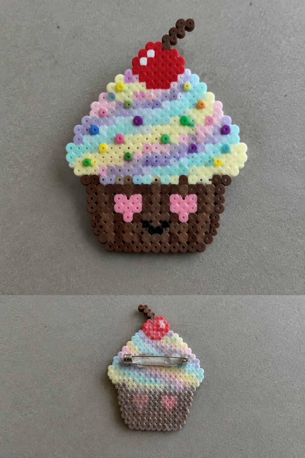 Perler bead cupcake pin front with cherry and face, back with safety pin.