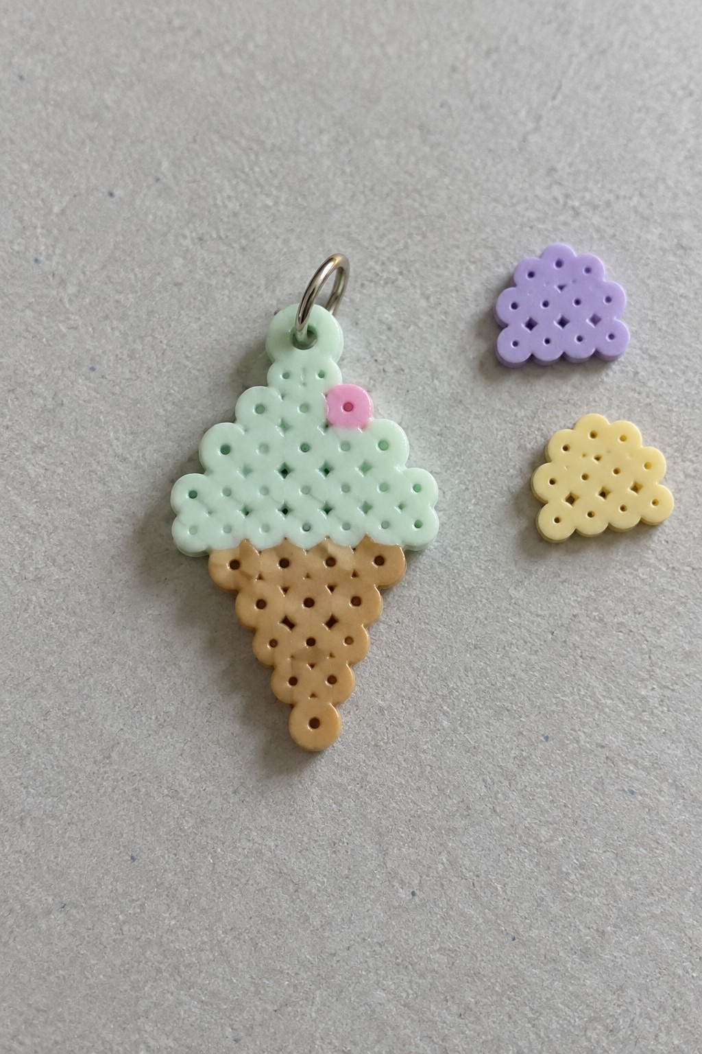 Perler bead ice cream cone keychain with mint scoop, brown cone, and two small shapes