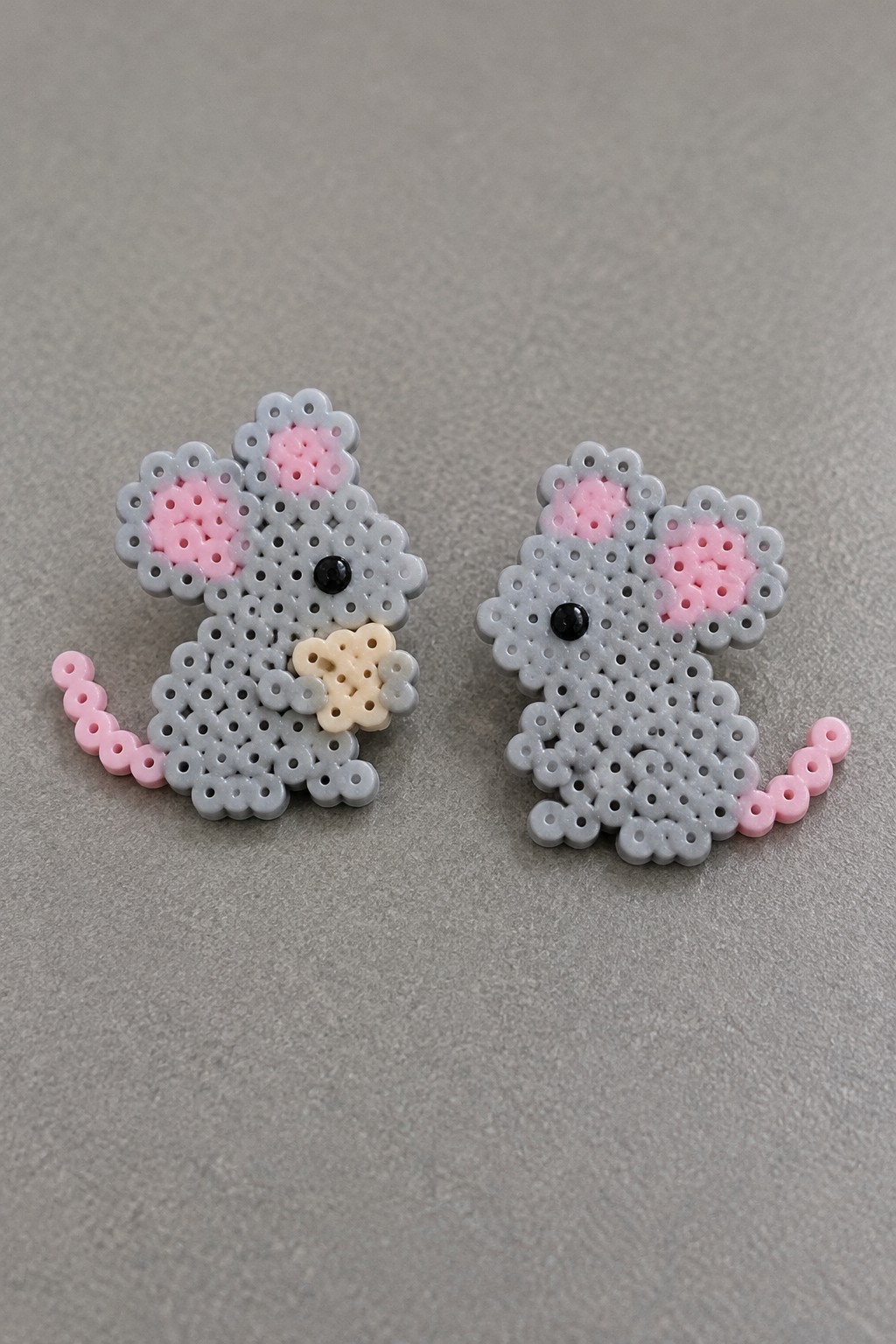 Two gray perler bead mice with pink ears, tails, and black eyes.